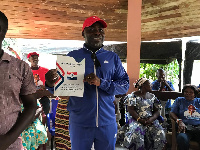 Former Secretary to the erstwhile IMCIM, Charles Bissue holding the nomination form