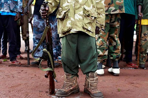 A former child soldier holds a gun, PHOTO | FILE | NATION MEDIA GROUP