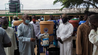 Saddique Boniface handing over the items