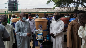 Saddique Boniface handing over the items