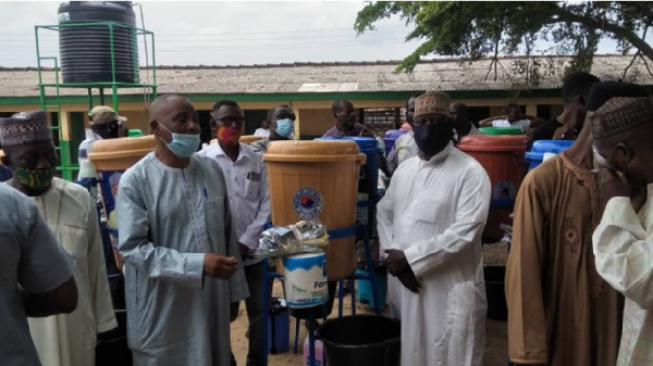 Saddique Boniface handing over the items