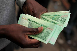 A man holds bond notes released by the Reserve Bank Of Zimbabwe in Harare, WILFRED KAJESE | AFP