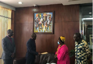 Reverend Enoch Nii Narh Thompson, presenting the cheque to Akosua Frema Opare-Osei