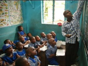 Teacher in class with schoolchildren, this is the time to teach the children about corruption