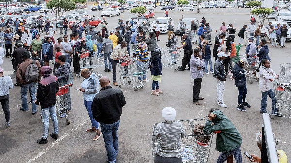 Hundreds of people line up to stock up on supplies