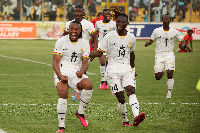 Some Black Stars playing celebrating after their victory