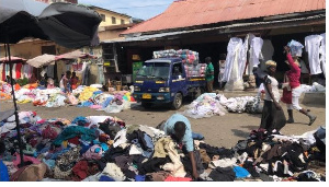 Piles of clothing and fabric can be found throughout Kantamanto market.(Stacey Knott/VOA)