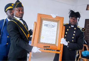 Captain George Yaw Buabeng (R) receiving the chatter of Commandry