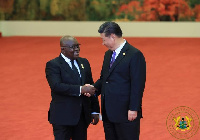 China's Xi Jinping (r) welcoming Akufo-Addo (l) to China for an official state visit