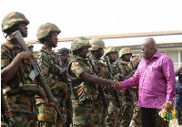 Akufo-Addo interacting with some military men while inspecting a guard of honour