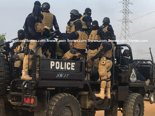 Armed police officers wearing masks at the Ayawaso West Wuogon by-election