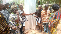 Dr. Nene Sipim Narh Terkpetey II (left) presenting the items to school authorities