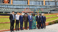 Ursula Owusu-Ekuful in a group photograph with officials of Whale Cloud after the signing ceremony