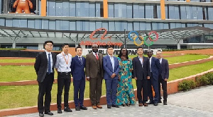 Ursula Owusu-Ekuful in a group photograph with officials of Whale Cloud after the signing ceremony