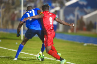 Kotoko player (in red) attempts to gain possession of the ball