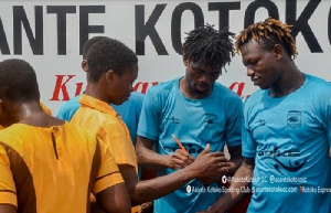 Asante Kotoko players with school kids