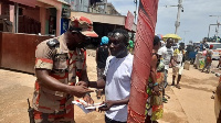 A fire service person enlightening a resident on fire management