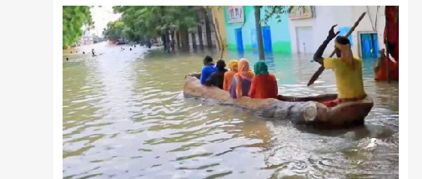 Following heavy rains, people used boats to get around the Somali town of Bardere