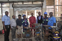 Students (in safety helmets) with KsTU registrar and other senior staff | Photo supplied