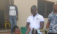 Alexander Frimpong  presenting the items to beneficiaries