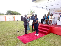 Deputy Attorney General, Godfred Dame presenting the citation to Mercy Tagoe