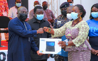 Vice president, Dr. Bawumia presenting a laptop to teachers