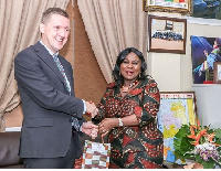 Madam Dapaah (right) presenting a parcel to Mr Walter