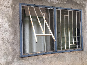 The cut window of one of the burgled homes, through which the robbers entered