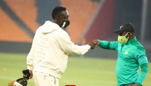 Ghana goalkeeper Richard Ofori fist-bumping a member of the technical team