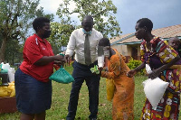 The girl and her mother receive an assortment of items from Genevieve Bamwidhukire.