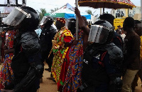 Osaberima being guarded by heavily armed police officers