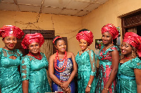 A wedding party wearing matching attire, or aso ebi.