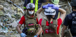 Rescuers clearing the rubble of the Ohmatdyt children's hospital in Kyiv