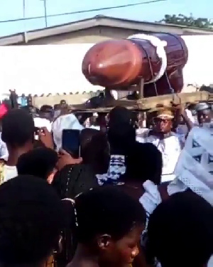 Pallbearers carrying the casket at the funeral grounds