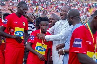 Sports Minister, Isaac Asiamah decorating Matthew Cudjoe with a medal