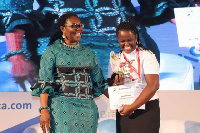 The Communications Minister, Ursula Owusu-Ekuful presenting the award to Selasi Domi-Kuwornu