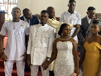 Obeng Junior holds the hand of his wife