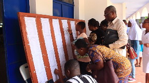 Some parents cross-checking names of their wards on the notice board