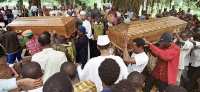 Flag-clad coffins holding the seven bodies headed towards the Festival square for burial