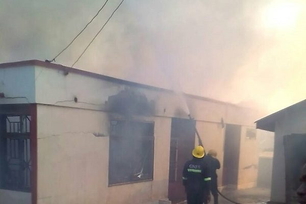 Fire service personnel attempt to douse the flames