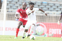 Joash Ochieng (left) of Kenya tackle Christian Atsu Twasam of Ghana during their 2019 AFCON