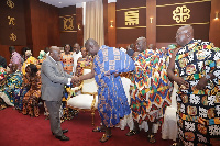 President Akufo-Addo (in suit) in a handshake with Osagyefo Oseadeyeyo Agyemang-Badu