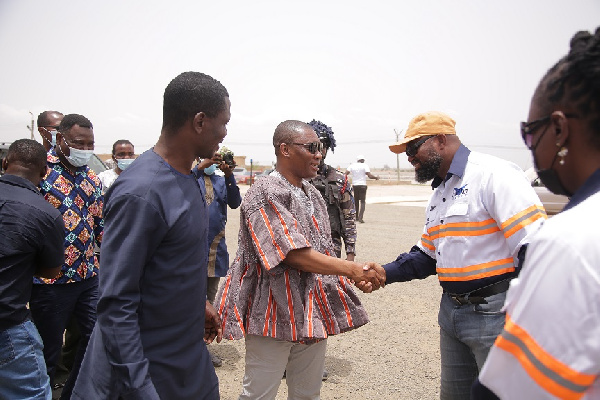 Hon. Mireku Duker (in smock) in a handshake with Dr. Daniel Mckorley