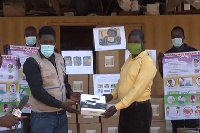 Victor Raul Puobabangna  Plance (left) presenting one of the projectors to Joseph Zida