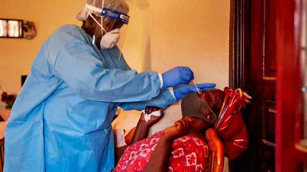 A health official takes a sample from a woman in Juba | ALEX McBRIDE | AFPa