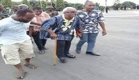 80-year-old leader of the group, Papavi Hogbedetor being escorted