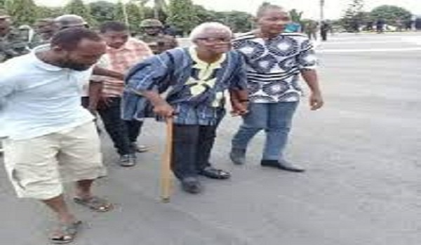 80-year-old leader of the group, Papavi Hogbedetor being escorted