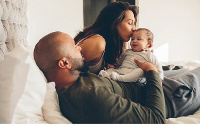 A photo of a couple with their baby