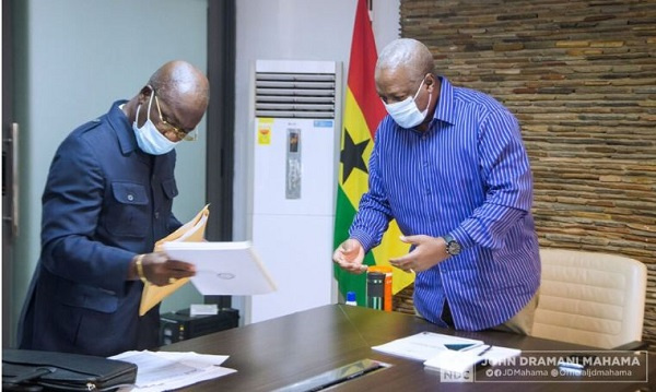 Former president John Dramani Mahama receiving a copy of the manifesto from the team