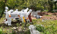 File photo: Environmental health officials on a mass burial of COVID-19 victims.